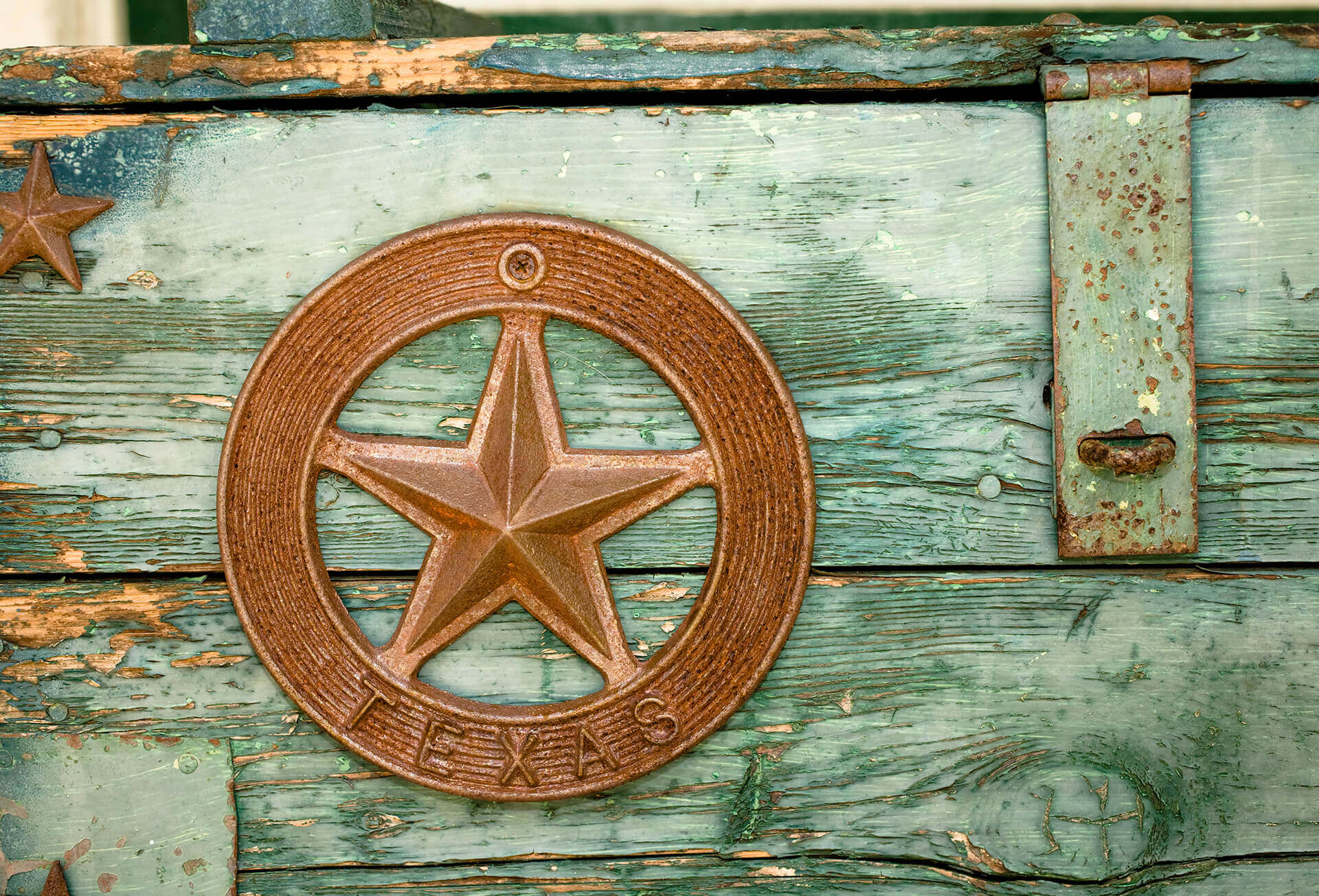 Green paint peeling on Wooden box with Texas star
